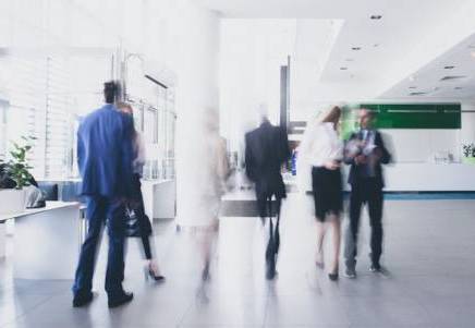 Blurred business professionals in a modern Leeds office, representing FinTech sector growth for Lenvi