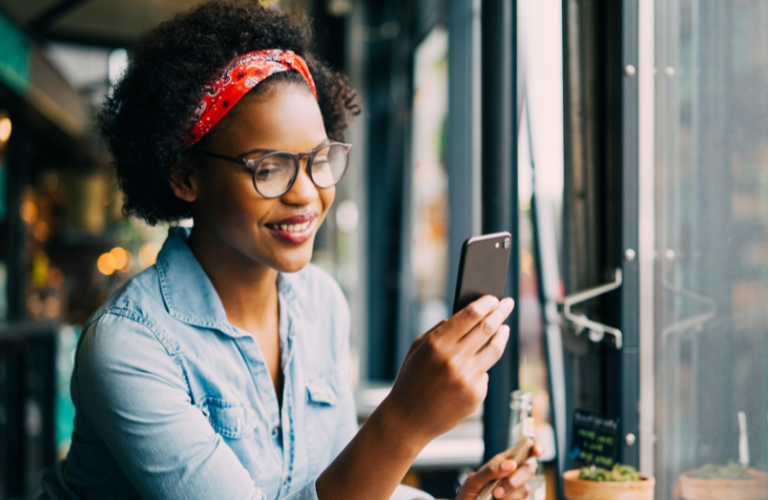 Smiling woman working on screen, representing proactive credit risk management and customer support