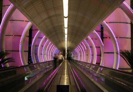 Illuminated modern tunnel with escalators, symbolising Lenvi's boosted European banking expertise and new hire Ian Miller