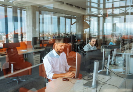 Professionals working in a modern office, representing the need for back up servicing providers for lenders - Lenvi Insights